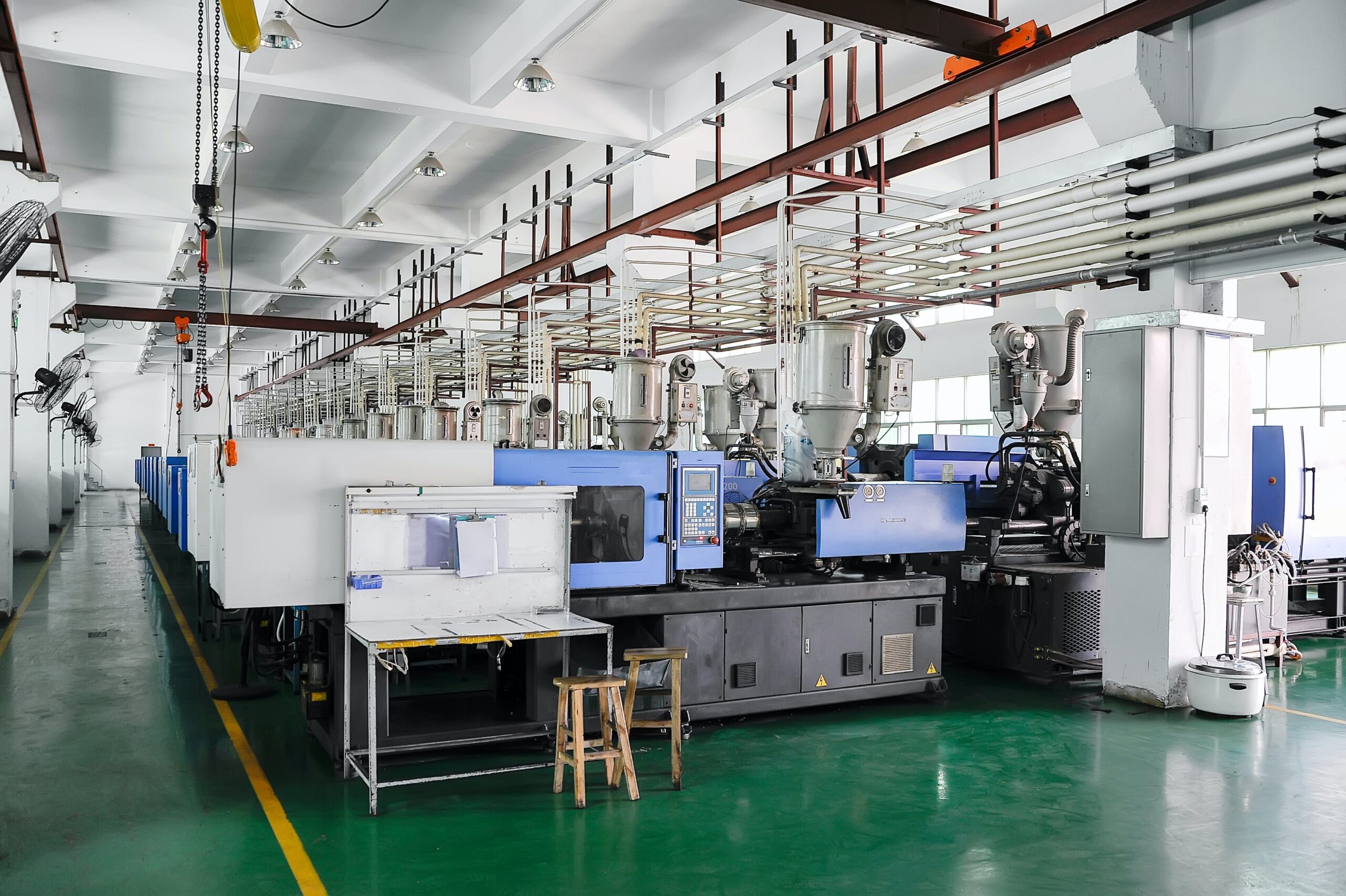 Row of plastic injection CNC machines at empty workshop